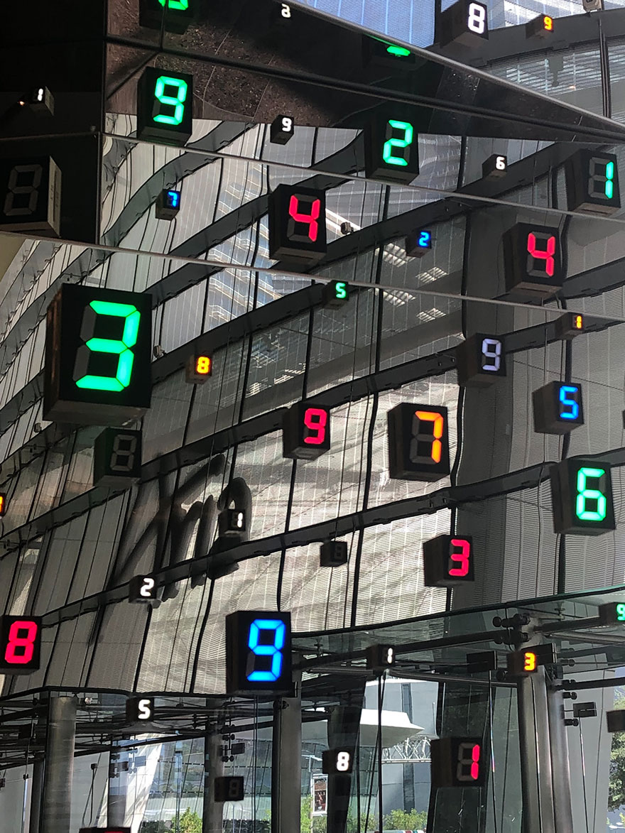 digital number signs scattered on a glass building