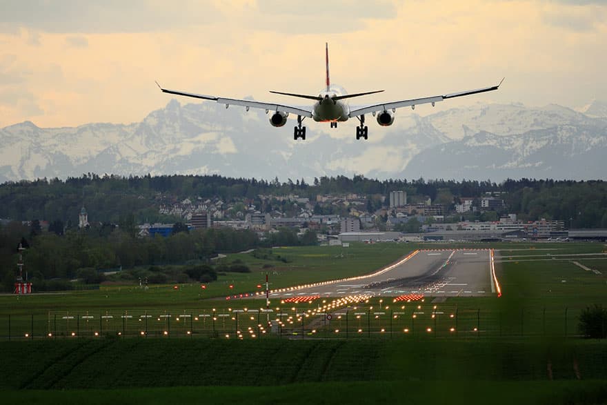 plane landing on a well lit runway