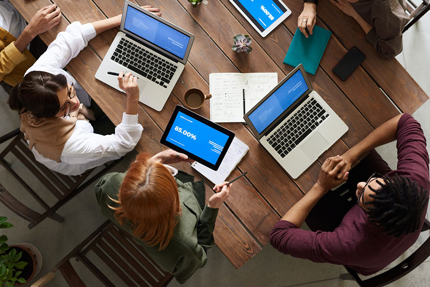 Top View Photo of Group of People Using laptops While Discussing
