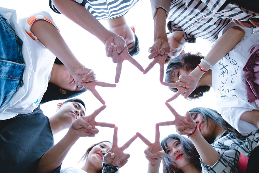 group of friends doing a star formation with their hands