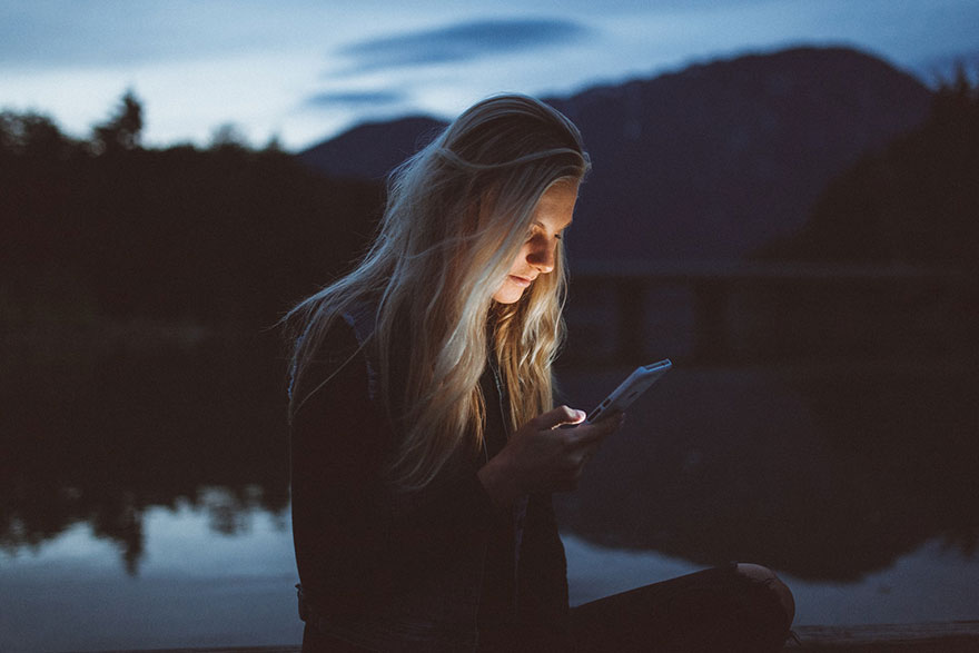 woman texting outside at during nighttime