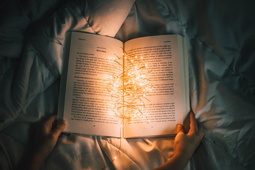 photo of an open book with lights on it