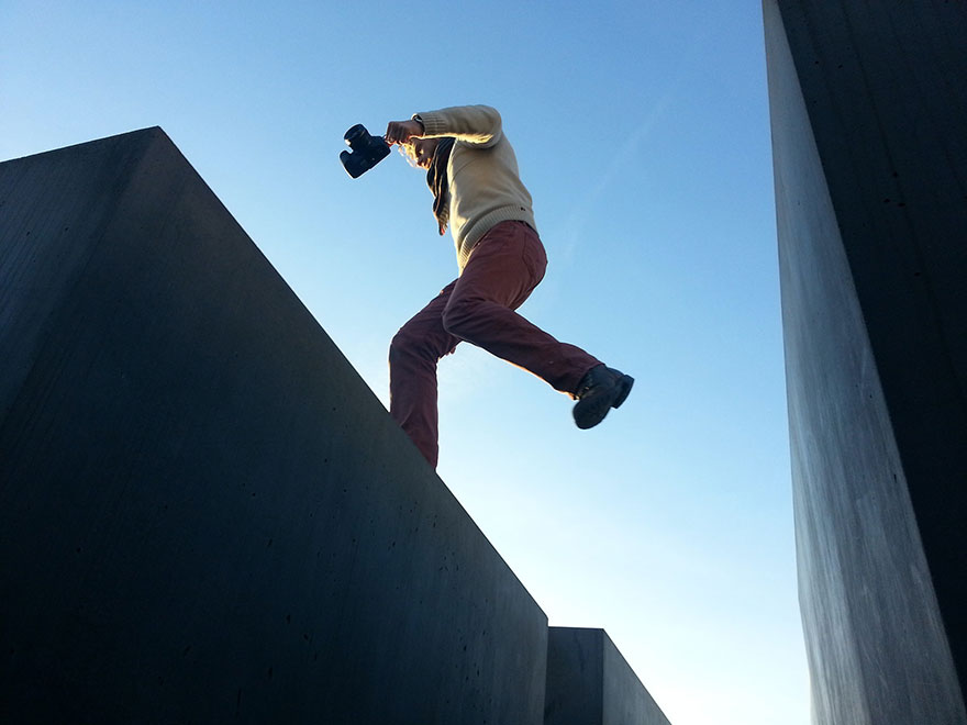 person jumping over a building gap