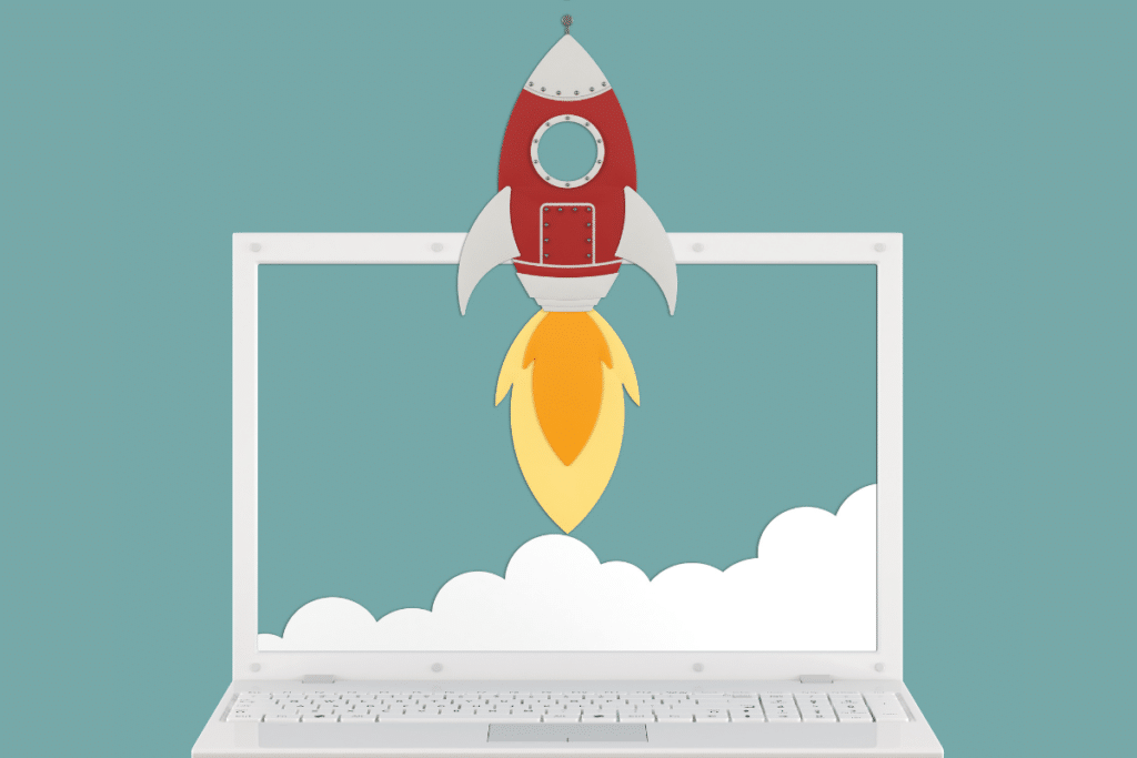 Drawing of a laptop with clouds on the screen and a rocket soaring up and above the laptop screen