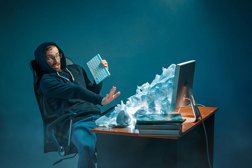 Young stressed businessman working at his desk