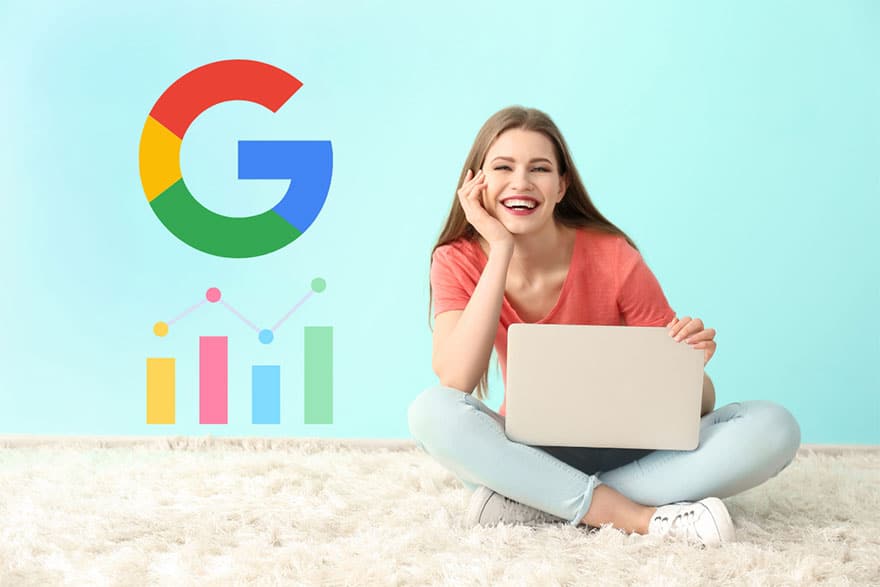 A smiling young woman sitting on the floor with a laptop next to the Google logo