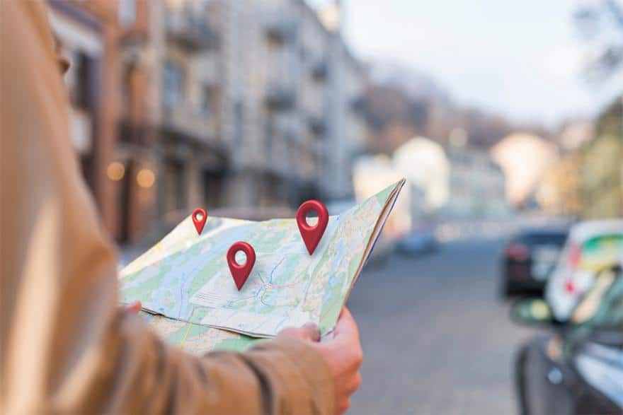 Person holding a map with location pins on it